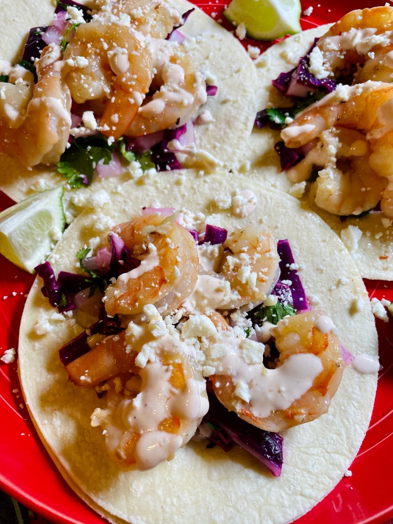 shrimp tacos with a sriracha crema and red cabbage slaw